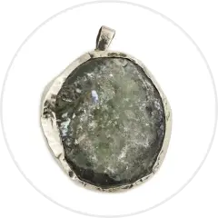 Rough green gemstone pendant with a silver frame.